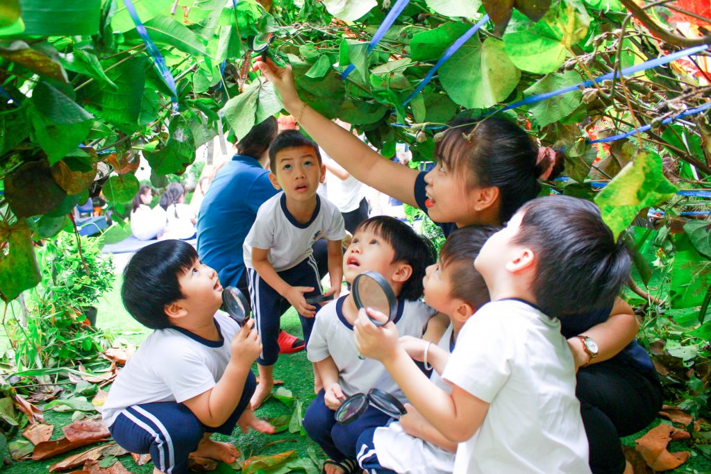 Kindy City students playing under hand-made branches