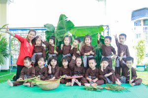 Kindy City students enjoy hut building, cỏ gà grass fighting and banana- stem toy guns